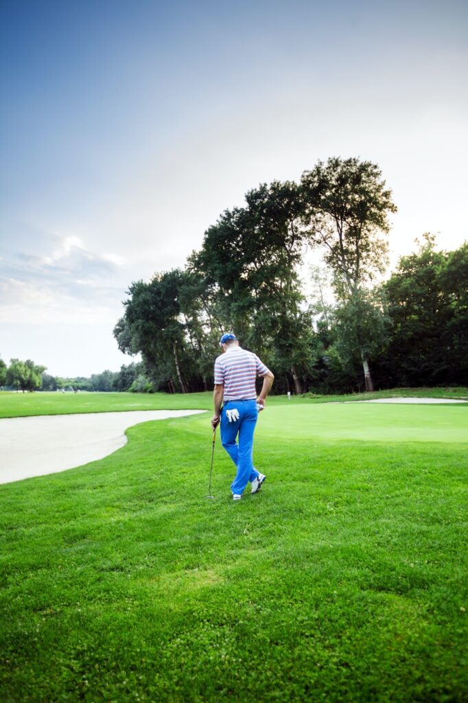 Beautiful golfing scenery with a golfer holding a club